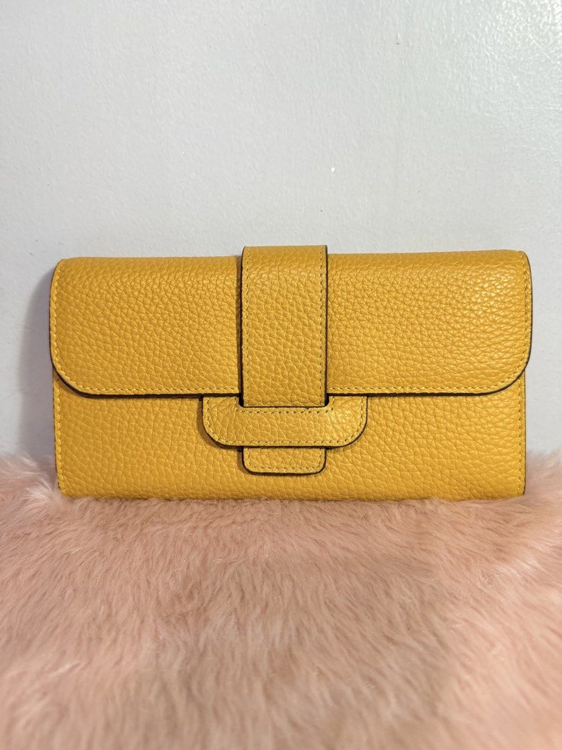 Bright Yellow Pebble Grain Leather Long Wallet (Category: Wallets & Card holders) located in Quezon City. Submitted by shaberbree (Listing ID 1466915199, Image 1). Description: - Color: Bright yellow with brown interior - Material: Pebble grain texture - Closure: Secure magnetic snap front flap - Storage: Multiple card slots and a center zippered coin compartment - Condition: Clean inside and out - Ideal for: Daily use or as a grab-and-go wallet 