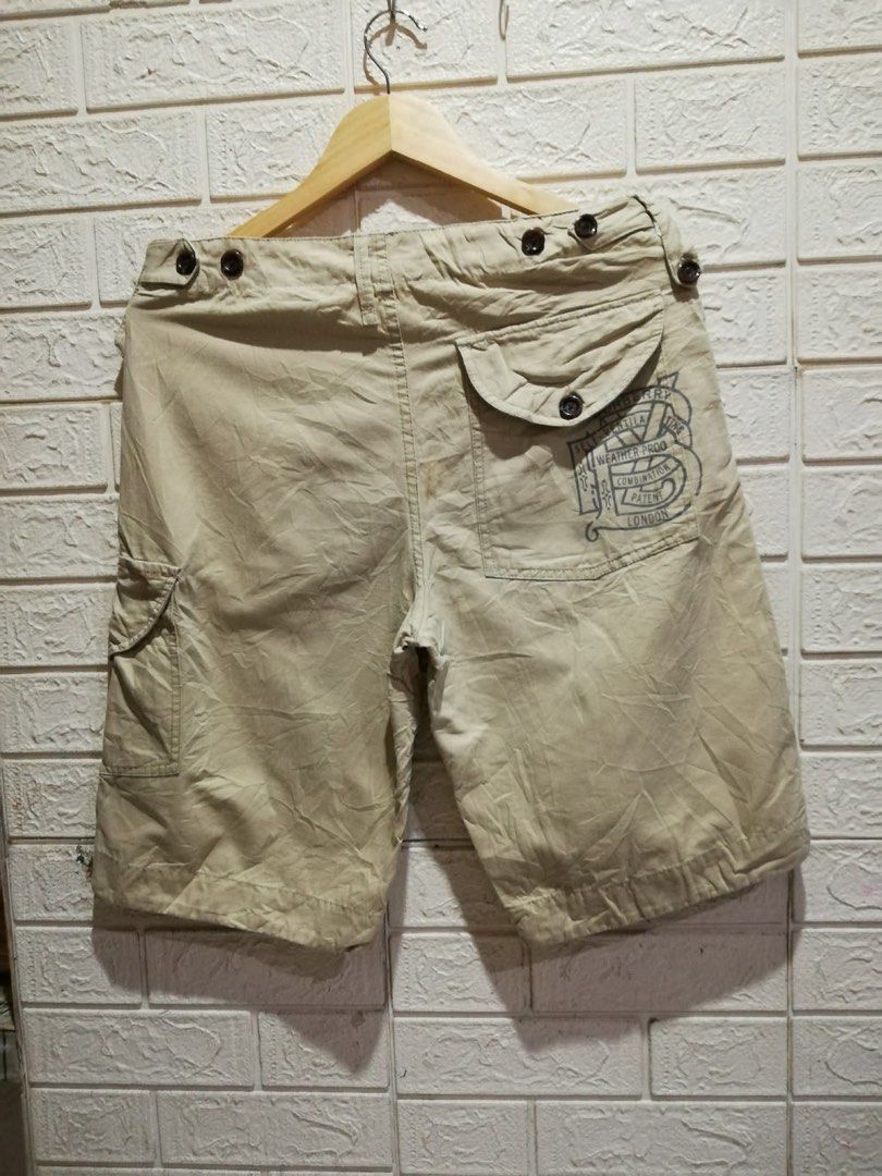 Burberry Brit Khaki Cargo Shorts (Category: Shorts) located in Rizal. Submitted by tiangarcia02 (Listing ID 1466931100, Image 2). Description: - Brand: Burberry Brit - Color: Khaki Beige - Material: 100% Cotton (Made in China) - Features: Multiple side and back pockets, stylish waist button details, and unique graphic print on the back right pocket - Care: Machine washable - Style: Casual, perfect for everyday wear.