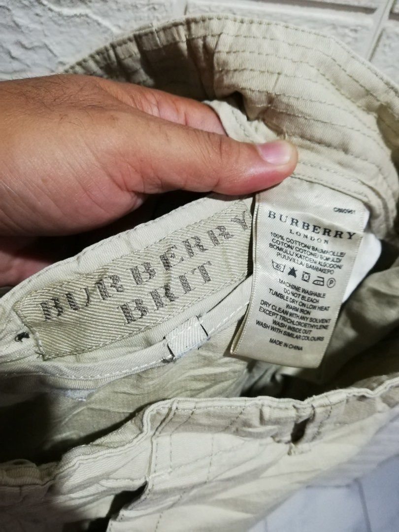 Burberry Brit Khaki Cargo Shorts (Category: Shorts) located in Rizal. Submitted by tiangarcia02 (Listing ID 1466931100, Image 3). Description: - Brand: Burberry Brit - Color: Khaki Beige - Material: 100% Cotton (Made in China) - Features: Multiple side and back pockets, stylish waist button details, and unique graphic print on the back right pocket - Care: Machine washable - Style: Casual, perfect for everyday wear.
