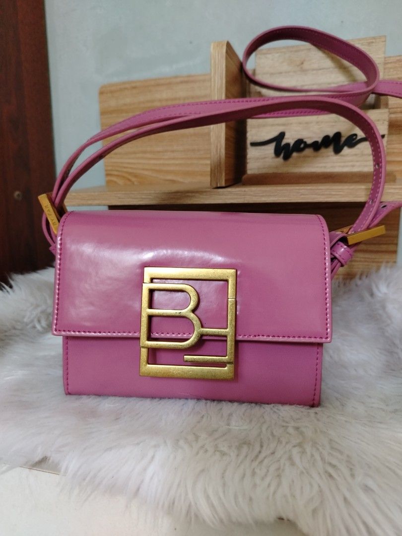 By Far Fran Minin (Category: Luxury Bags & Wallets) located in Lucena. Submitted by gracious_chin0436 (Listing ID 1466792122, Image 1). Description: - Brand: By Far - Color: Pink - Material: Patent Leather - Style: Structured boxy shoulder bag - Closure: Front flap with magnetic snap button - Hardware: Premium gold-tone accents and logo buckle - Strap: Adjustable - Condition: have some deform on side part slight creased .