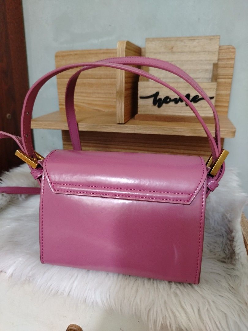 By Far Fran Minin (Category: Luxury Bags & Wallets) located in Lucena. Submitted by gracious_chin0436 (Listing ID 1466792122, Image 2). Description: - Brand: By Far - Color: Pink - Material: Patent Leather - Style: Structured boxy shoulder bag - Closure: Front flap with magnetic snap button - Hardware: Premium gold-tone accents and logo buckle - Strap: Adjustable - Condition: have some deform on side part slight creased .