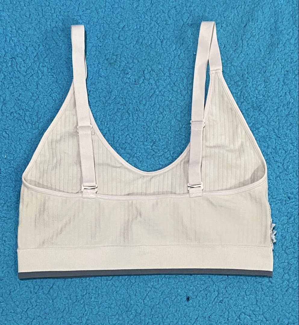 Calvin Klein Beige Ribbed Bralette with Adjustable Straps (Category: Sleeveless) located in Bacolod City. Submitted by bravefire_3fe6dd (Listing ID 1466805738, Image 3). Description: - Brand: Calvin Klein - Color: Classic Beige - Design: Scoop neck with adjustable back straps - Band: Comfortable elastic underband with iconic CK logo text - Padding: Includes removable cup inserts - Material: Stretchy, seamless fabric for all-day comfort - Conditio