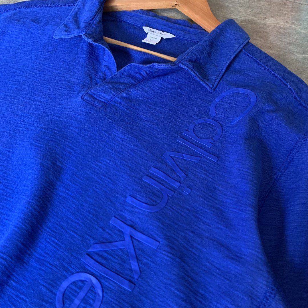 Calvin Klein Buttonless Script Polo Shirt (Category: Tshirts & Polo Shirts ) located in Tibiao. Submitted by notaveragethrift (Listing ID 1466794137, Image 3). Description: Width- 23 Length- 30 CR- 9.8/10 or better Excellent Condition Already washed,ready to wear✅ No crack prints No issue.