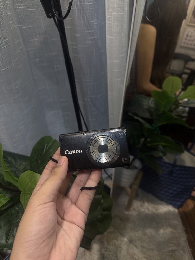Canon PowerShot A2300 HD Digital Camera Black (Category: Cameras) located in Calamba. Submitted by leeadriannn796 (Listing ID 1466893362, Image 1). Description: Canon PowerShot A2300 HD digital camera in black. Compact 16.0 megapixel model with 5x optical zoom lens. Includes attached wrist strap. Standard buttons on the back and top on/off switch. Bottom tripod mount and battery compartment door. Pocket-sized point and shoot camera for casual pho