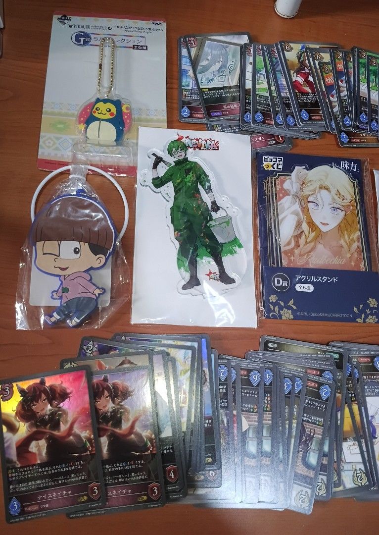 Cards and charms (Category: Trading Cards Accessories) located in Las Pinas. Submitted by jennyheaven (Listing ID 1466814535, Image 2). Description: - 105pcs Shadowverse Evolve cards (21pcs holos, 84pcs regular - 3pcs acrylic standees - 11pcs charms.
