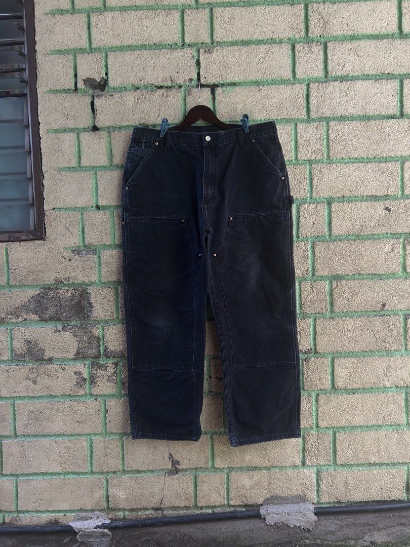 Carhartt Double Front Work Pants Black Made in USA (Category: Jeans) located in Bauan. Submitted by thrift.enough (Listing ID 1466803414, Image 1). Description: Black Carhartt double front work pants. Classic utility style with reinforced knees and multiple tool pockets. Hammer loop on the side. Made in the USA tag at the waistband. Heavy canvas material with a nice fade from wear. Back patch pocket with the Carhartt logo patch. Solid pair for wo