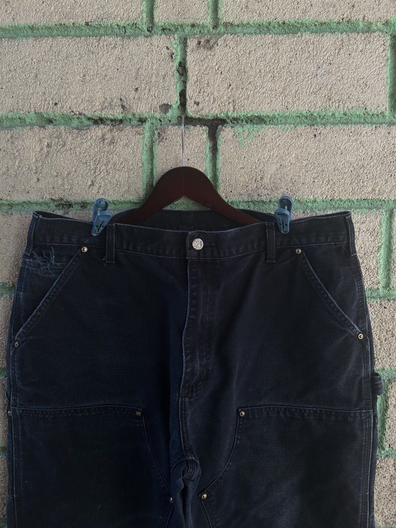 Carhartt Double Front Work Pants Black Made in USA (Category: Jeans) located in Bauan. Submitted by thrift.enough (Listing ID 1466803414, Image 3). Description: Black Carhartt double front work pants. Classic utility style with reinforced knees and multiple tool pockets. Hammer loop on the side. Made in the USA tag at the waistband. Heavy canvas material with a nice fade from wear. Back patch pocket with the Carhartt logo patch. Solid pair for wo