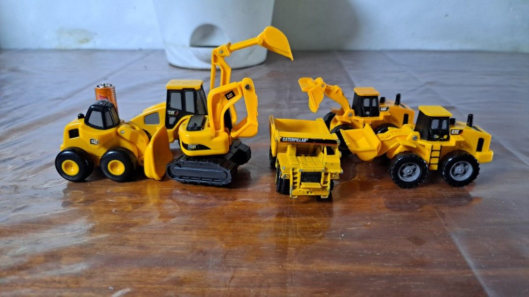 Caterpillar CAT Mini Toy Construction Vehicles Set (Category: Kids Toys) located in Quezon City. Submitted by hersheejubilo (Listing ID 1466903292, Image 1). Description: - Complete Caterpillar construction toy set - Includes excavator on tracks, dump truck, front loaders, and wheeled loader - Classic yellow and black design - Good size variety across all vehicles - Perfect for playtime or collecting - Selling strictly as a set (all together).