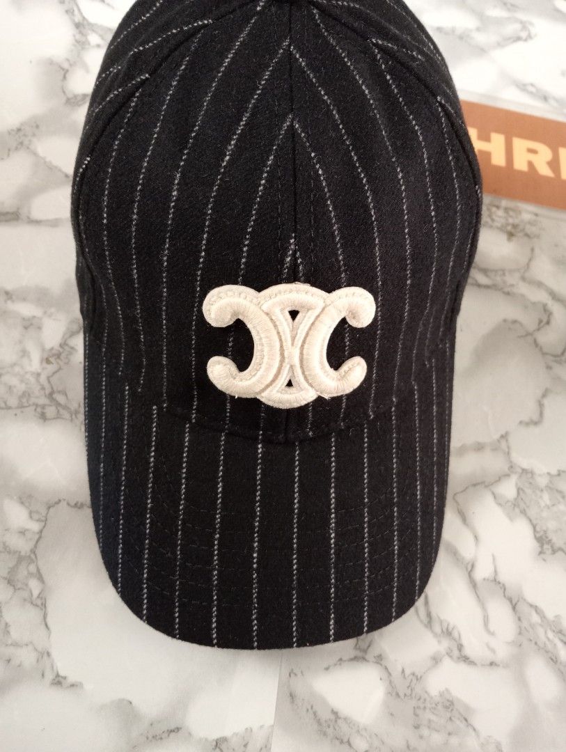 Celine Pinstripe Baseball Cap with Triomphe Patch Size M (Category: Caps & Hats) located in Tarlac. Submitted by luxsourze (Listing ID 1466968247, Image 2). Description: Celine Paris Cap in Black with White Pinstripes. Made in France Large Embroidered Triomphe Logo patch on the front in cream. Adjustable Back Strap featuring a gold-tone buckle with engraved Celine branding. Interior lined with Celine Logo tape. Size medium tag attached inside. Ad