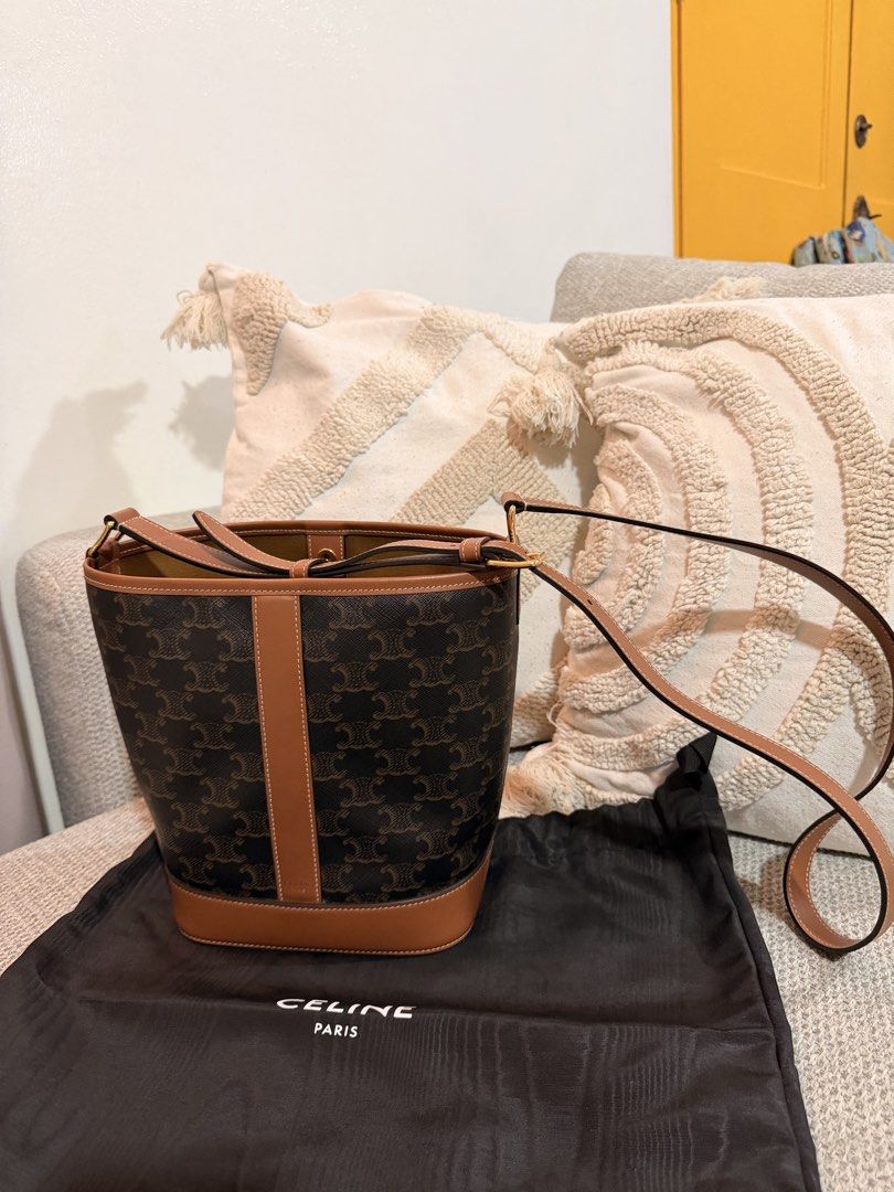 Celine Triomphe Canvas Bucket Bag (Category: Luxury Bags & Wallets) located in San Pedro. Submitted by kathlynaviles_ (Listing ID 1466948181, Image 1). Description: - Brand: Celine - Style: Bucket Bag in Brown Triomphe Canvas with Tan Leather Trim - Hardware: Gold-tone - Strap: Adjustable shoulder strap - Interior: Tan suede lining with snap button closure - Condition: Excellent, clean exterior and interior, hardly used with practically no flaws 