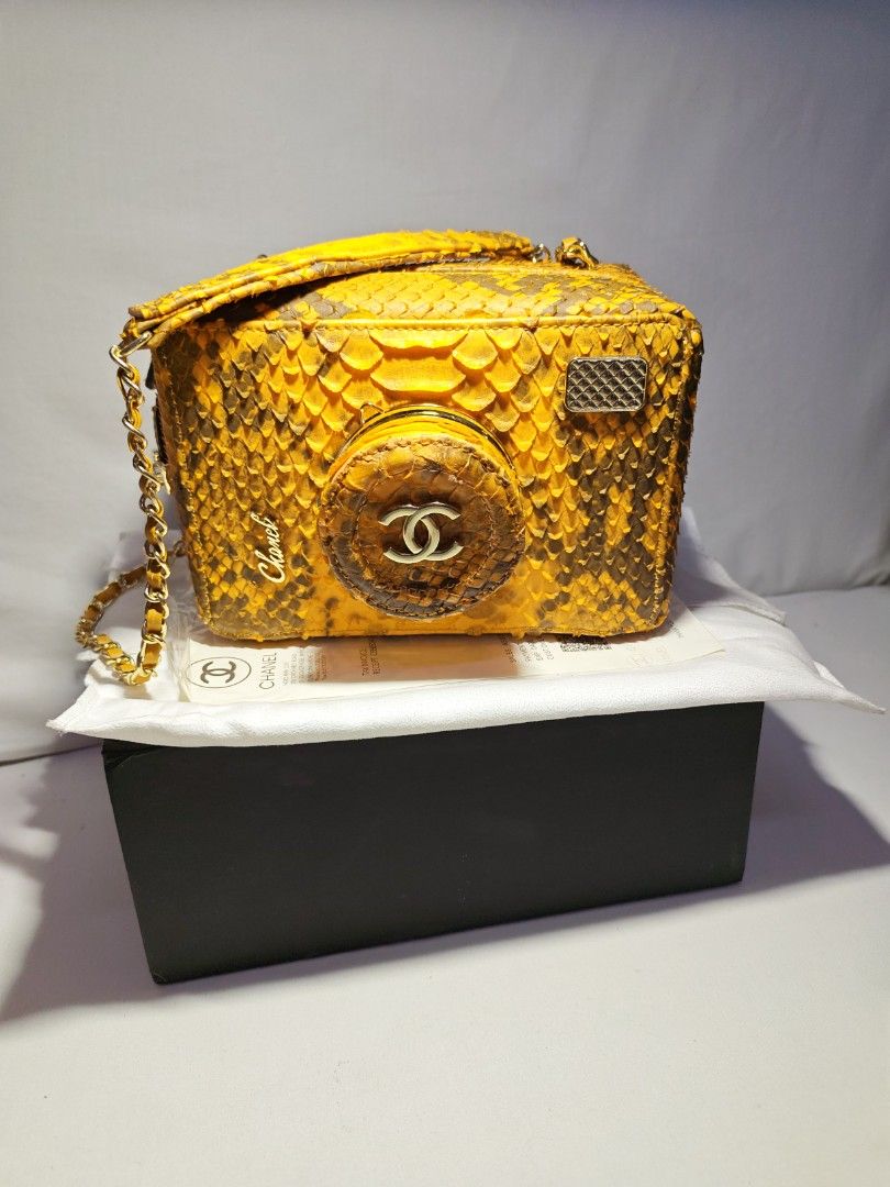 CHANEL YELLOW PYTHON PATTERN DESIGN CAMERA CASE CROSSBODY BAG (Category: Luxury Bags & Wallets) located in Quezon City. Submitted by sparkys.joy_88 (Listing ID 1466886359, Image 3). Description: - Chanel camera case crossbody bag - Rare yellow python pattern design exterior with black fabric interior lining - Iconic circular camera-lens front motif with gold-tone interlocking CC logo - Secure zip-around closure - Signature chain strap interwoven 