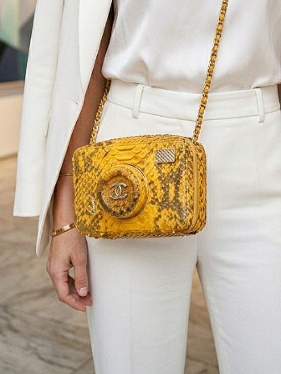 CHANEL YELLOW PYTHON PATTERN DESIGN CAMERA CASE CROSSBODY BAG (Category: Luxury Bags & Wallets) located in Quezon City. Submitted by sparkys.joy_88 (Listing ID 1466886359, Image 1). Description: - Chanel camera case crossbody bag - Rare yellow python pattern design exterior with black fabric interior lining - Iconic circular camera-lens front motif with gold-tone interlocking CC logo - Secure zip-around closure - Signature chain strap interwoven 