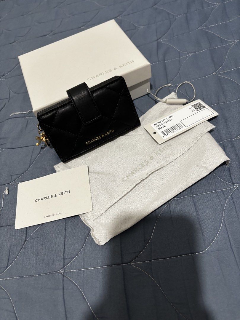 Charles & Keith Arrietty (Category: Wallets & Card holders) located in Manila. Submitted by declutter_byjaq (Listing ID 1466931768, Image 1). Description: CHARLES & KEITH ARRIETTY Details: Brand: Charles & Keith Style: Arrietty Style Code: CK6-50701613 Colour: Black Condition: Excellent Condition Usage: Used once only — good as new! A classy and timeless black card holder that's perfect for everyday use or special occasions. Elegant, versatile, a