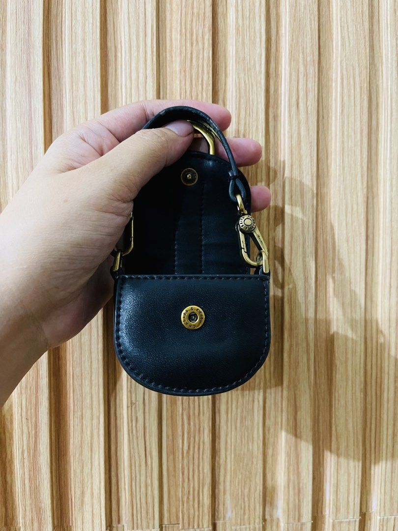 Charles & Keith Black Micro Bag Charm (Category: Charms) located in Manila. Submitted by yhaan04 (Listing ID 1466919934, Image 3). Description: - Brand: Charles & Keith - Color: Black with chic gold-tone hardware - Closure: Front flap with magnetic snap button - Details: Gold logo stamped on the back, interior brand tag - Versatile Use: Features a clasp handle, ideal for hanging on larger bags or storing tiny items.