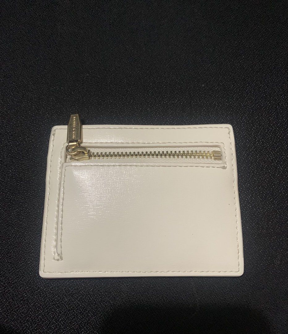 charles & keith carli wallet / card holder (Category: Wallets & Card holders) located in Manila. Submitted by santanajdd (Listing ID 1466832284, Image 2). Description: Charles & Keith Carli Multi-Slot Card Holder 💕 * color: cream * authentic, excellent condition * saffiano PU material * size: 10 x 8 x 0.9 cm * features: 3 card slots + 1 zip compartment.