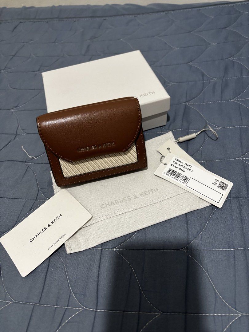 Charles & Keith Enola (Category: Wallets & Card holders) located in Manila. Submitted by declutter_byjaq (Listing ID 1466929429, Image 1). Description: CHARLES & KEITH ENOLA Details: Brand: Charles & Keith Style: Enola Style Code: CK6-10770715-1 Colour: Chocolate Condition: Excellent Condition Usage: Used thrice only — good as new! Chic, classy, and timeless! The beautiful chocolate colour makes this wallet easy to match with your favourite bags 