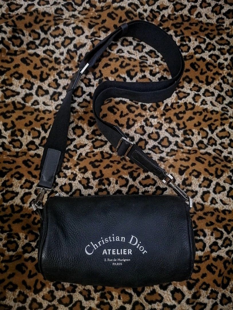 Christian Dior Atelier roller bag (Category: Sling Bags) located in Cebu City. Submitted by roadthrift (Listing ID 1466782808, Image 1). Description: Highlights black cylindrical shape leather zip fastening adjustable shoulder strap logo print Condition: Lightly used. .