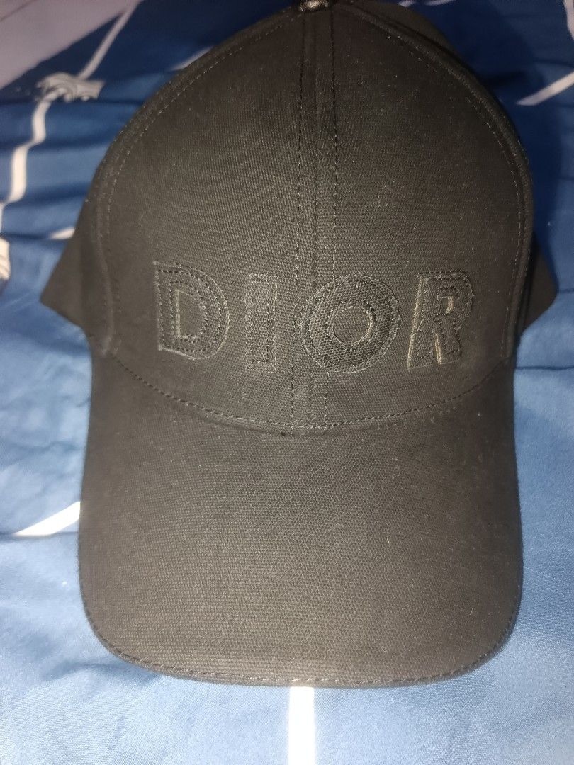 Christian Dior Black Embroidered Baseball Cap (Category: Caps & Hats) located in Manila. Submitted by julianivan50757 (Listing ID 1466954192, Image 1). Description: Black baseball cap from Christian Dior. Bold embroidered DIOR lettering across the front. Adjustable leather strap closure at the back with metal hardware and CD logo. Interior features Christian Dior Boutique Paris tag and cotton-coton care label. Classic six-panel construction with 