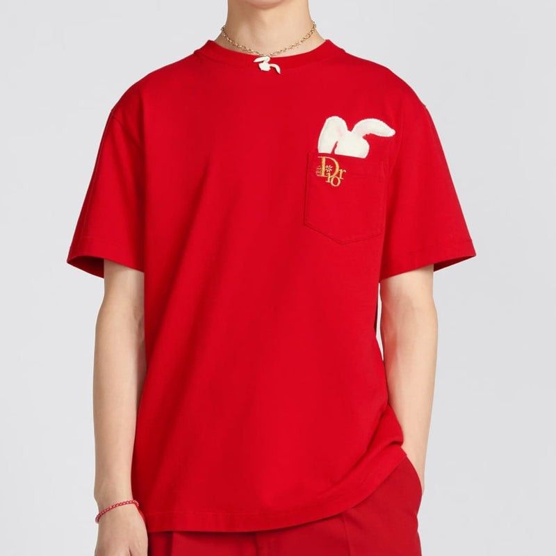 Christian Dior x ERL (Category: Tshirts & Polo Shirts ) located in Ligao. Submitted by kokaakf1nds. (Listing ID 1466896567, Image 1). Description: dimes - 21 " 27 - Authentic Christian Dior red cotton t-shirt - Size: Medium (fits true to size) - Features a playful white plush rabbit sticking out of the chest pocket - Detailed with a gold embroidered Dior logo below the pocket - Classic crew neck and short sleeves - Made in Italy tag inside - Clea