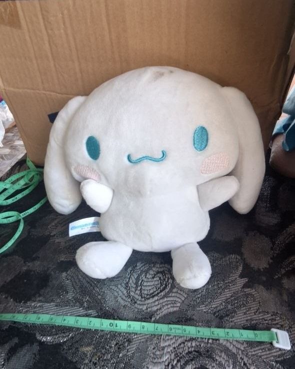 Cinnamoroll – Sanrio Seated Plush (Category: Plushies & Soft Toys) located in Paombong. Submitted by revox.store (Listing ID 1463660723, Image 2). Description: Sanrio • Cinnamoroll • Plush Included: ✓ Cinnamoroll seated plush with blue embroidered eyes and spiral tail ✓ Official Cinnamoroll fabric tush tag attached Flaws: • Visible surface smudge on top of head and faint rear soil spots (needs washing) 📍 On-hand (Paombong, Bulacan) 🚚 Ships nati