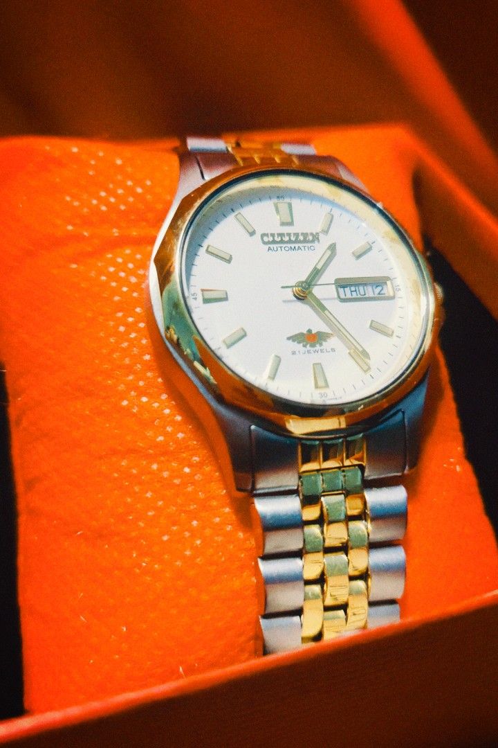 Citizen Eagle 7 Automatic 21 Jewels Two-Tone Watch with Box (Category: Men's Watches) located in Santa Rosa. Submitted by casper_dghost (Listing ID 1466964006, Image 2). Description: - Brand: Citizen Automatic Watch - Dial: Clean white dial with a 3 o'clock day-date window - Movement: Reliable 21 jewels automatic movement - Strap: Elegant gold and silver two-tone jubilee-style bracelet - Condition: Keeps accurate time - Inclusions: Comes complete