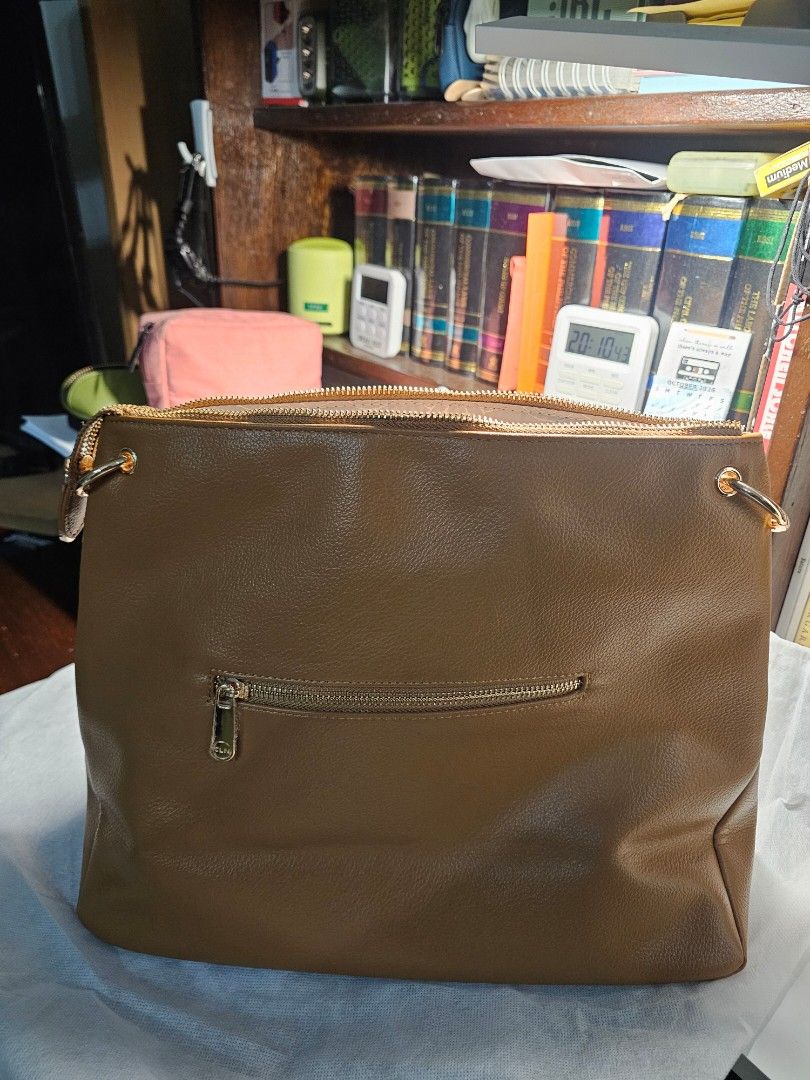 CLN 1025D Sammy Shoulder Bag Brown (Category: Shoulder Bags) located in Paranaque City. Submitted by mizniteowl (Listing ID 1466918217, Image 2). Description: Reason for selling: Not my style. Given as a gift. UNUSED. Description: CLN Sammy shoulder bag in brown. Zip closure on top, extra zip pocket on the back. Gold-tone hardware details. Interior lined with patterned fabric, includes slip and zip compartments. Still has original store tag attac