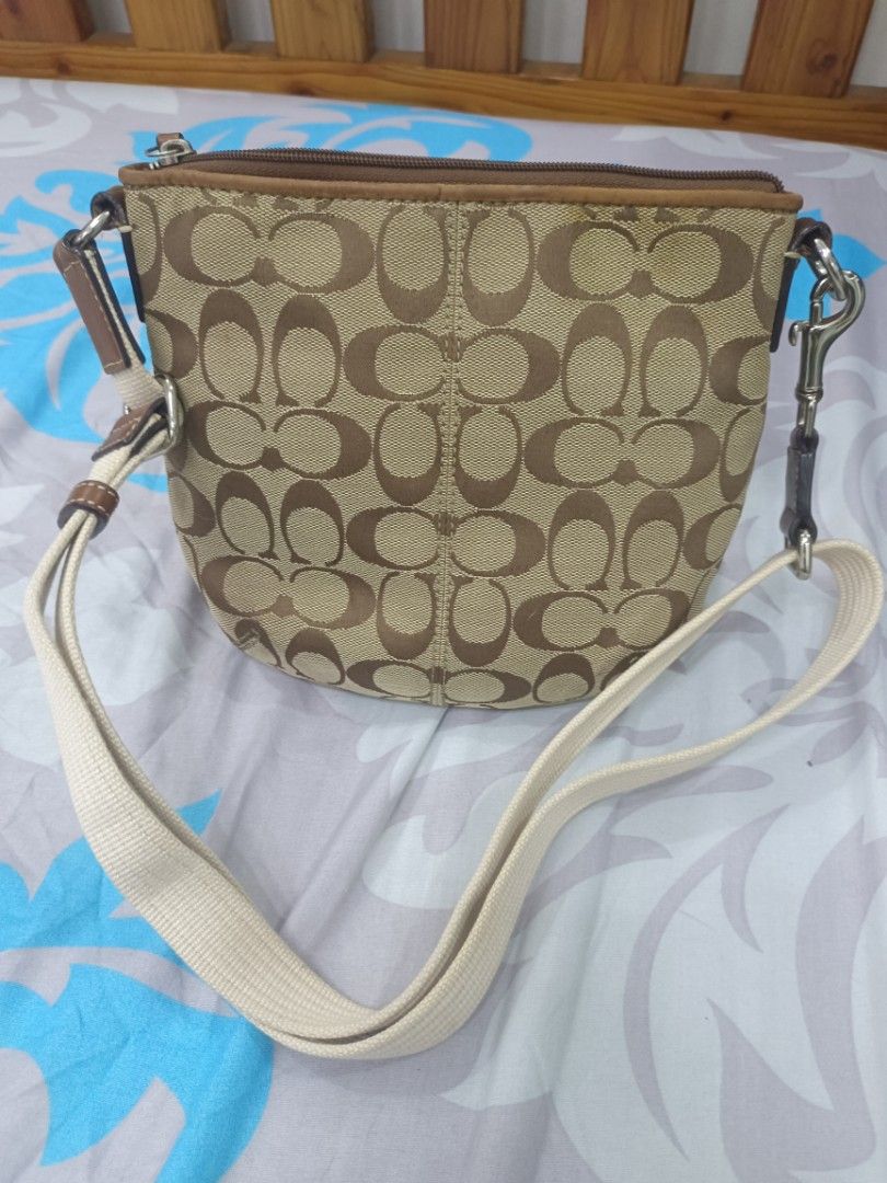 Coach Beige Brown Crossbody Bag (Category: Luxury Bags & Wallets) located in Quezon City. Submitted by ochea28 (Listing ID 1466884239, Image 2). Description: - Authentic Coach crossbody bag - Signature beige and brown canvas with brown leather trim - Top zip closure for security - Exterior front open slip pocket - Adjustable canvas shoulder strap - Dark fabric interior lining with a convenient zip pocket - Dimensions: approx. 20 cm (H) x 23 cm (W