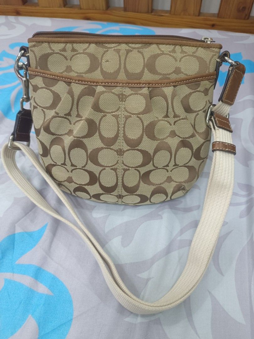 Coach Beige Brown Crossbody Bag (Category: Luxury Bags & Wallets) located in Quezon City. Submitted by ochea28 (Listing ID 1466884239, Image 1). Description: - Authentic Coach crossbody bag - Signature beige and brown canvas with brown leather trim - Top zip closure for security - Exterior front open slip pocket - Adjustable canvas shoulder strap - Dark fabric interior lining with a convenient zip pocket - Dimensions: approx. 20 cm (H) x 23 cm (W