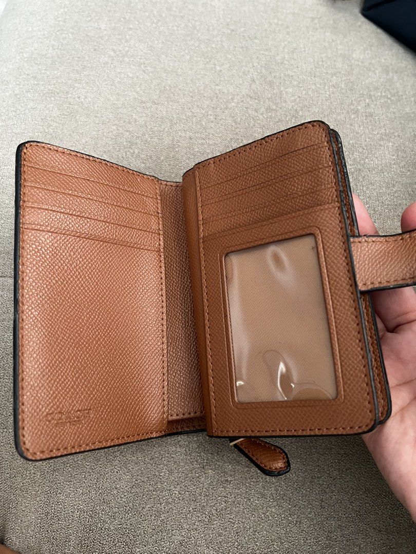 Coach Brown Leather Medium Zip Around Wallet (Category: Luxury Bags & Wallets) located in Santa Rosa. Submitted by etjam (Listing ID 1466800712, Image 3). Description: Brown leather Coach wallet with multiple card slots and an ID window. Includes cash compartment and zip coin pouch. Secure snap closure keeps everything in place. Classic saddle brown colour matches most bags. Compact size fits easily in everyday purses..