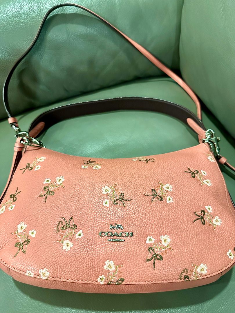 Coach Floral Bow Print Leather Shoulder Bag (Category: Luxury Bags & Wallets) located in Calamba. Submitted by clearoutbyc (Listing ID 1466833669, Image 1). Description: - Authentic Coach shoulder bag in pink pebble leather - Features cute embroidered floral and bow motifs - Silver-tone hardware with Coach New York front logo - Secure zip-top closure with a clean interior and exterior - Versatile design includes a short handle, detachable tassel 