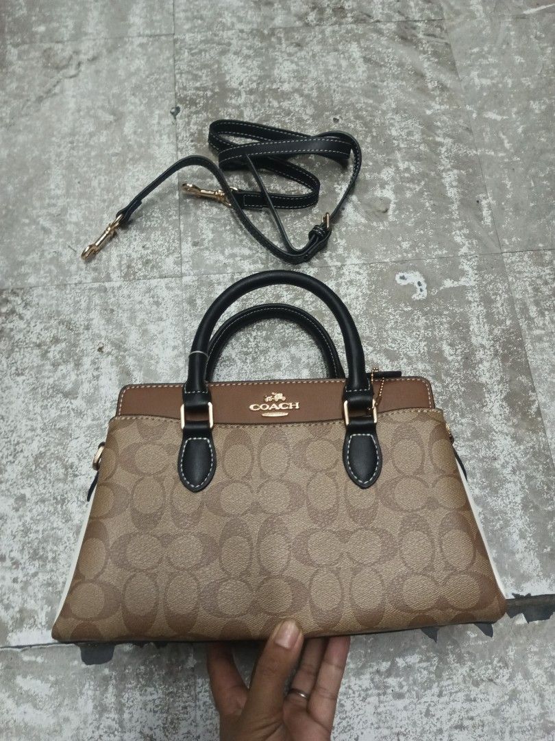 Coach Mini Darcie Carryall Colorblock (Category: Cross-body Bags) located in Baguio. Submitted by brandeditems16 (Listing ID 1466965104, Image 1). Description: - Brand: Coach - Design: Signature monogram print with chic black and brown leather panels - Hardware: Premium gold-tone accents throughout - Versatility: Features dual top handles and a convenient detachable shoulder strap - Closure: Secure zip-top closure - Interior: Clean dark fabric li