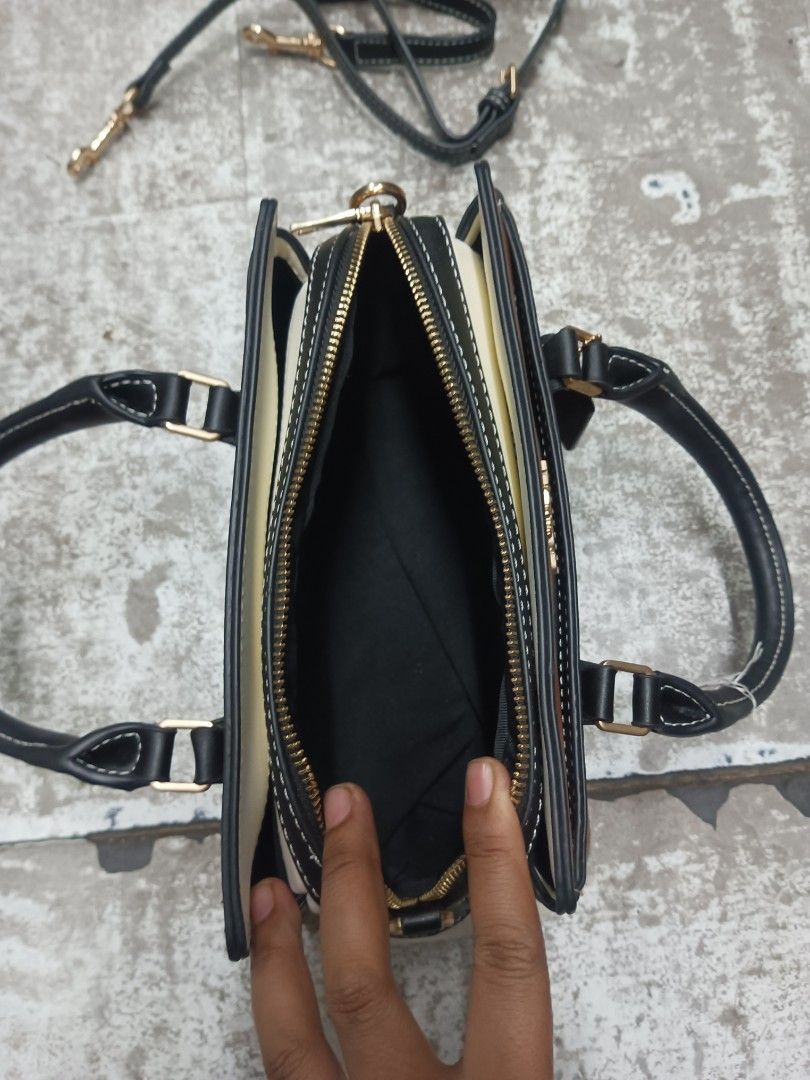 Coach Mini Darcie Carryall Colorblock (Category: Cross-body Bags) located in Baguio. Submitted by brandeditems16 (Listing ID 1466965104, Image 3). Description: - Brand: Coach - Design: Signature monogram print with chic black and brown leather panels - Hardware: Premium gold-tone accents throughout - Versatility: Features dual top handles and a convenient detachable shoulder strap - Closure: Secure zip-top closure - Interior: Clean dark fabric li