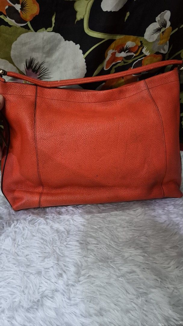 Coach Orange Pebbled Leather Shoulder Bag (Category: Luxury Bags & Wallets) located in Manila. Submitted by ertya (Listing ID 1466872522, Image 3). Description: self authentication no rubs shoulder bag.