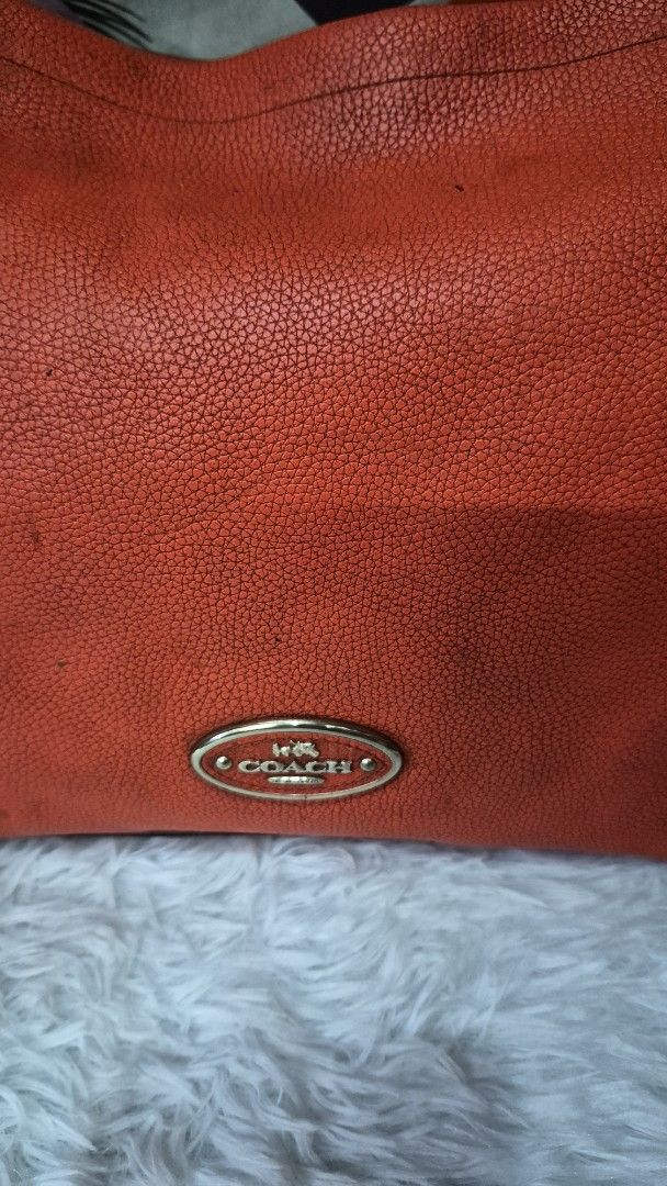 Coach Orange Pebbled Leather Shoulder Bag (Category: Luxury Bags & Wallets) located in Manila. Submitted by ertya (Listing ID 1466872522, Image 2). Description: self authentication no rubs shoulder bag.