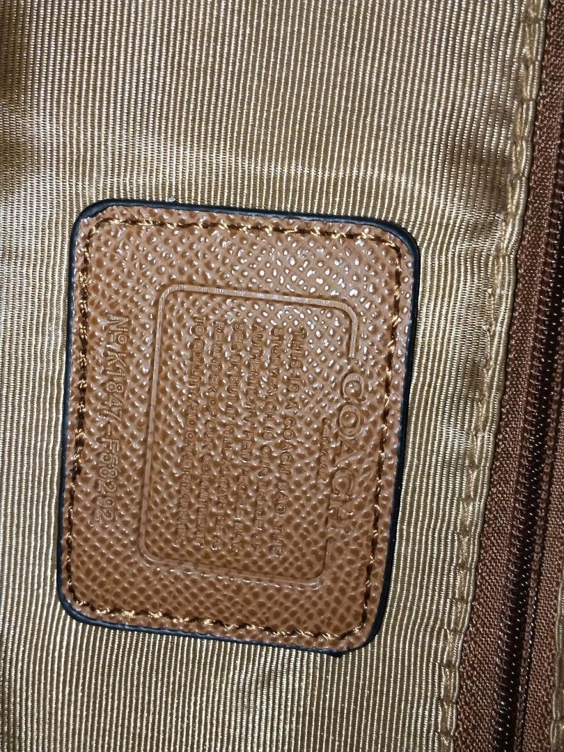 Coach Signature Brown Backpack F58292 (Category: Backpacks) located in Manila. Submitted by bagelyascollection (Listing ID 1466897982, Image 2). Description: Coach signature monogram print canvas backpack in brown. Features a front zip pocket, smooth tan leather-look side and back panels, and adjustable orange-brown fabric shoulder straps. Inside has satin lining with the Coach creed patch. Serial number stamped inside: F58292. Roomy everyday bag