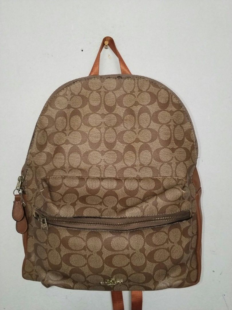 Coach Signature Brown Backpack F58292 (Category: Backpacks) located in Manila. Submitted by bagelyascollection (Listing ID 1466897982, Image 1). Description: Coach signature monogram print canvas backpack in brown. Features a front zip pocket, smooth tan leather-look side and back panels, and adjustable orange-brown fabric shoulder straps. Inside has satin lining with the Coach creed patch. Serial number stamped inside: F58292. Roomy everyday bag