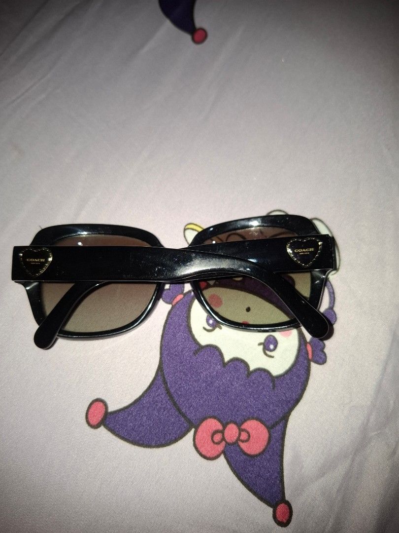 Coach Sunglasses (Category: Sunglasses & Eyewear) located in Manila. Submitted by usagichan_rabbit (Listing ID 1466871648, Image 3). Description: - Brand: Coach - Model: HC 8251 (L1052) - Frame Color: Black with stylish gold heart accents on both temples - Lenses: Dark gradient, perfect for sunny days - Shape: Classic oversized, solid build - Condition: Well kept, clearly marked with brand and model numbers with very slight scratch from hawaii no
