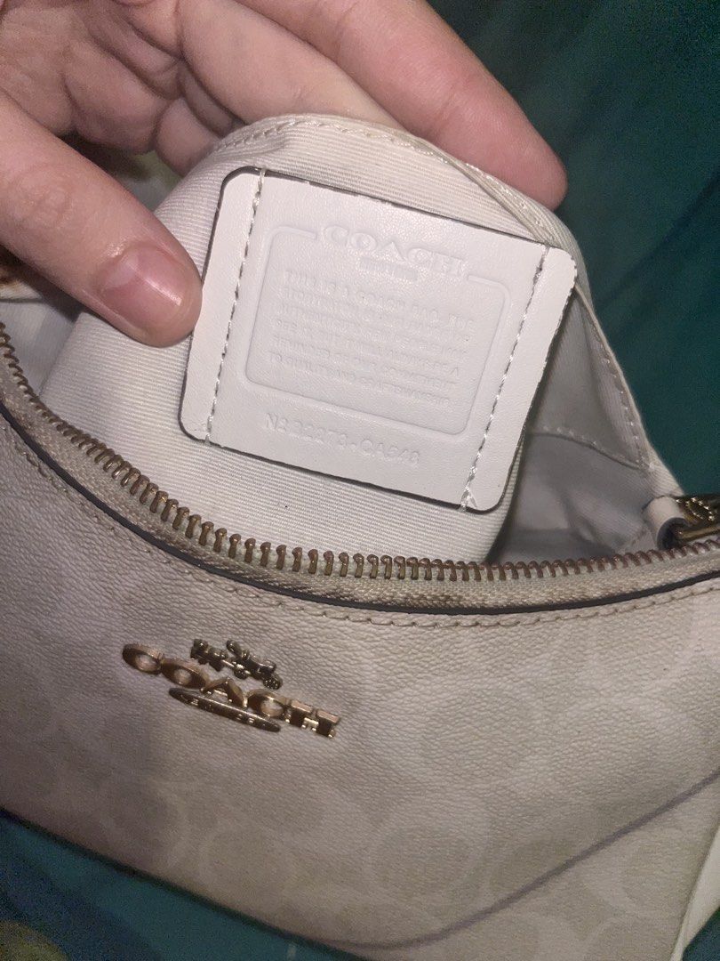 Coach White Signature Canvas Shoulder Bag (Category: Luxury Bags & Wallets) located in Manila. Submitted by scorpiana_ (Listing ID 1466951663, Image 2). Description: PRICE IS STILL NEGOTIABLE IF GET IMMEDIATELY - Coach shoulder bag in white signature canvas and smooth white leather trim - Elegant gold-tone chain strap and matching hardware - Secure zip-top closure with a clean interior lining - Features interior creed patch with style number B227
