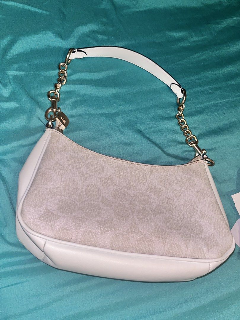 Coach White Signature Canvas Shoulder Bag (Category: Luxury Bags & Wallets) located in Manila. Submitted by scorpiana_ (Listing ID 1466951663, Image 3). Description: PRICE IS STILL NEGOTIABLE IF GET IMMEDIATELY - Coach shoulder bag in white signature canvas and smooth white leather trim - Elegant gold-tone chain strap and matching hardware - Secure zip-top closure with a clean interior lining - Features interior creed patch with style number B227
