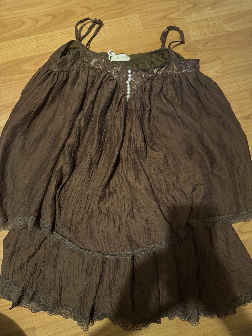 COLYN Brown Crinkle Two-Piece Set with Pearl Buttons (Category: Sets or Coordinates) located in Manila. Submitted by decluterthings888 (Listing ID 1466877410, Image 2). Description: - Brand: COLYN - Style: Brown two-piece set (cami top and matching skirt) - Material: Crinkled fabric with brown interior lining - Details: Lace trim along edges, V-neckline with faux pearl buttons - Top: Adjustable shoulder straps - Bottom: Comfortable elastic waistb
