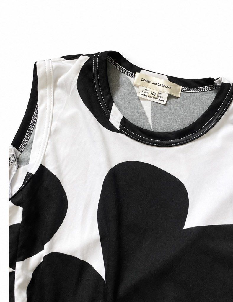 COMME des GARÇONS (Category: Dresses) located in Olongapo. Submitted by WAVYT (Listing ID 1466817245, Image 2). Description: - Brand: COMME des GARÇONS (AD2021 Collection) - Style: Sleeveless dress with round neckline and relaxed fit - Design: Bold black floral print on a white base with a mesh tulle hem - Size: XS - Material: 100% polyester body, 100% nylon trim - Origin: Made in Japan - Condition: Rare recent find, perfect statement piece.