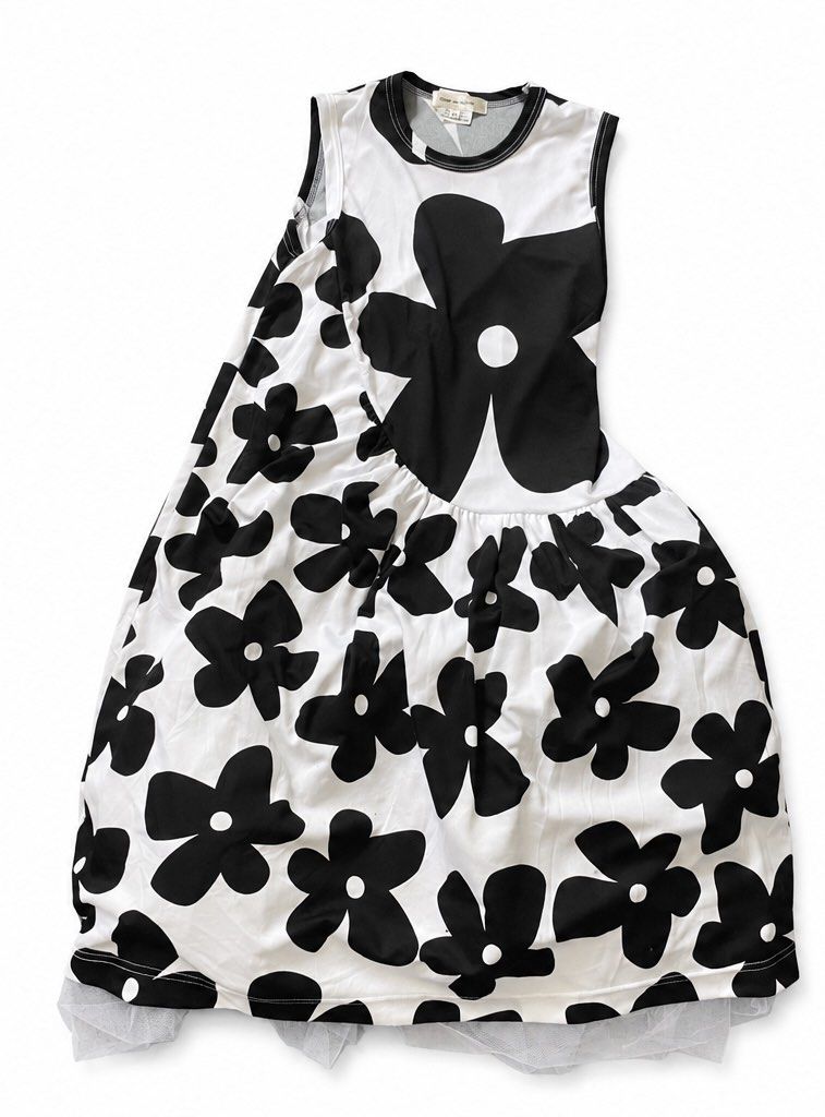 COMME des GARÇONS (Category: Dresses) located in Olongapo. Submitted by WAVYT (Listing ID 1466817245, Image 1). Description: - Brand: COMME des GARÇONS (AD2021 Collection) - Style: Sleeveless dress with round neckline and relaxed fit - Design: Bold black floral print on a white base with a mesh tulle hem - Size: XS - Material: 100% polyester body, 100% nylon trim - Origin: Made in Japan - Condition: Rare recent find, perfect statement piece.
