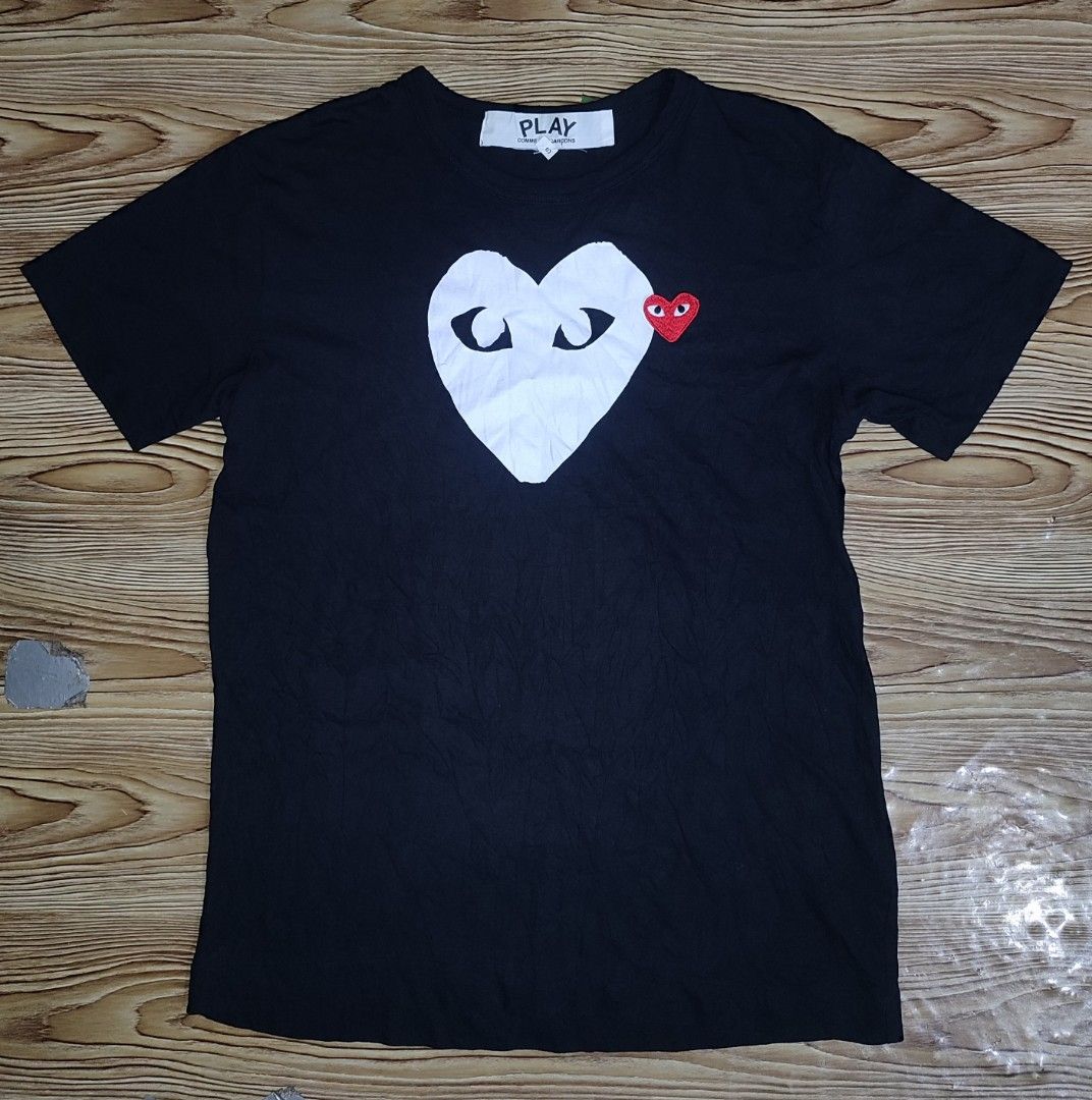 COMME des GARÇONS PLAY Black Heart Tee Size S (Category: Shirts) located in Davao. Submitted by valeriajan24414 (Listing ID 1466847549, Image 1). Description: - Brand: COMME des GARÇONS PLAY - Size: S - Material: 100% Cotton - Origin: Made in Japan - Design: Large white heart graphic with signature embroidered red heart patch - Details: Classic crew neck, short sleeves, model code AZ-T116 - Collection: AD2017 tag inside - Condition: 100% authenti