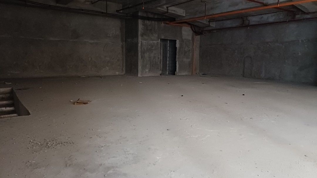 Commercial Space CBD ORTIGAS Pasig City (Category: Construction & Building Materials) located in Manila. Submitted by jo.caro1 (Listing ID 1466925850, Image 2). Description: Unfurnished commercial unit on the ground floor. Large open layout with raw concrete walls, high ceilings, and exposed pipes. Large glass storefront windows facing the street. Staircase leading down to a lower level area. Lots of natural light from the front facade. Great loc