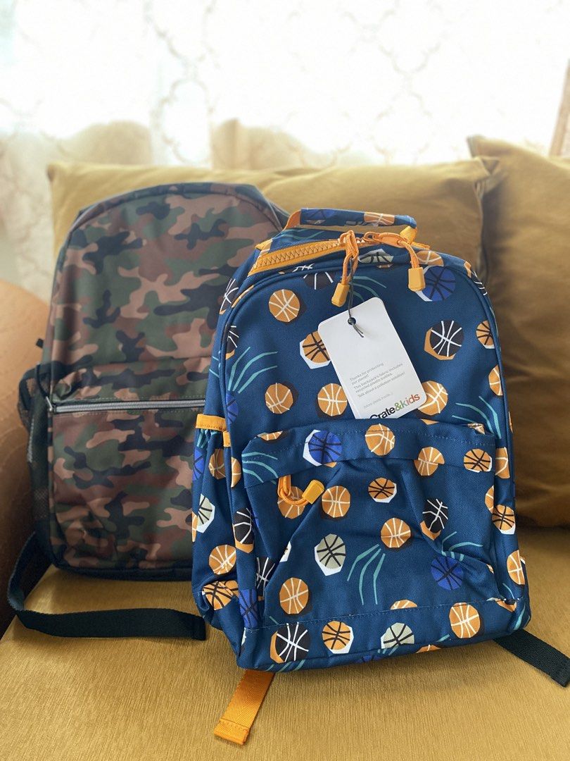 Crate & Kids Basketball Backpack and Camo Backpack Bundle (Category: Backpacks) located in Batangas. Submitted by lux_kimmy (Listing ID 1466883564, Image 1). Description: - Set of 2 versatile kids backpacks, perfect for school, sports, or day trips - Bag 1: Crate & Kids blue basketball print, brand new with original tags, features eco-friendly fabric and interior name tag slot - Bag 2: Classic camo design in green, brown, and black with Children 