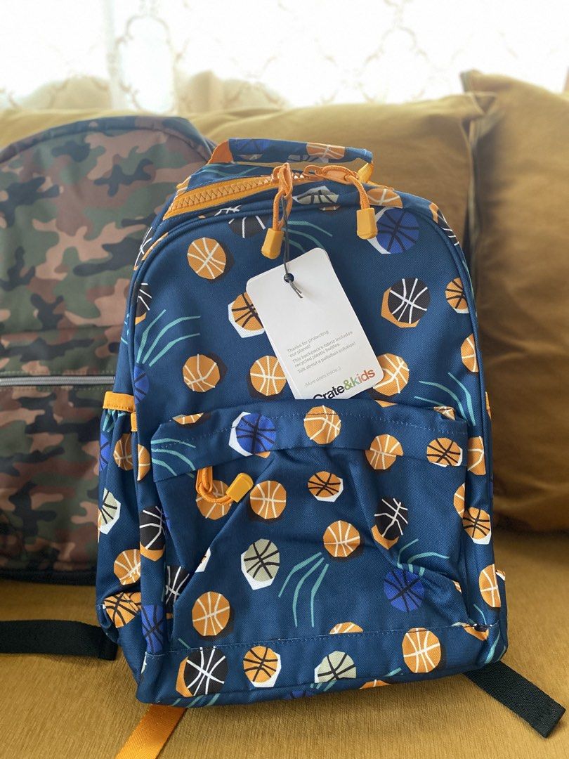 Crate & Kids Basketball Backpack and Camo Backpack Bundle (Category: Backpacks) located in Batangas. Submitted by lux_kimmy (Listing ID 1466883564, Image 2). Description: - Set of 2 versatile kids backpacks, perfect for school, sports, or day trips - Bag 1: Crate & Kids blue basketball print, brand new with original tags, features eco-friendly fabric and interior name tag slot - Bag 2: Classic camo design in green, brown, and black with Children 