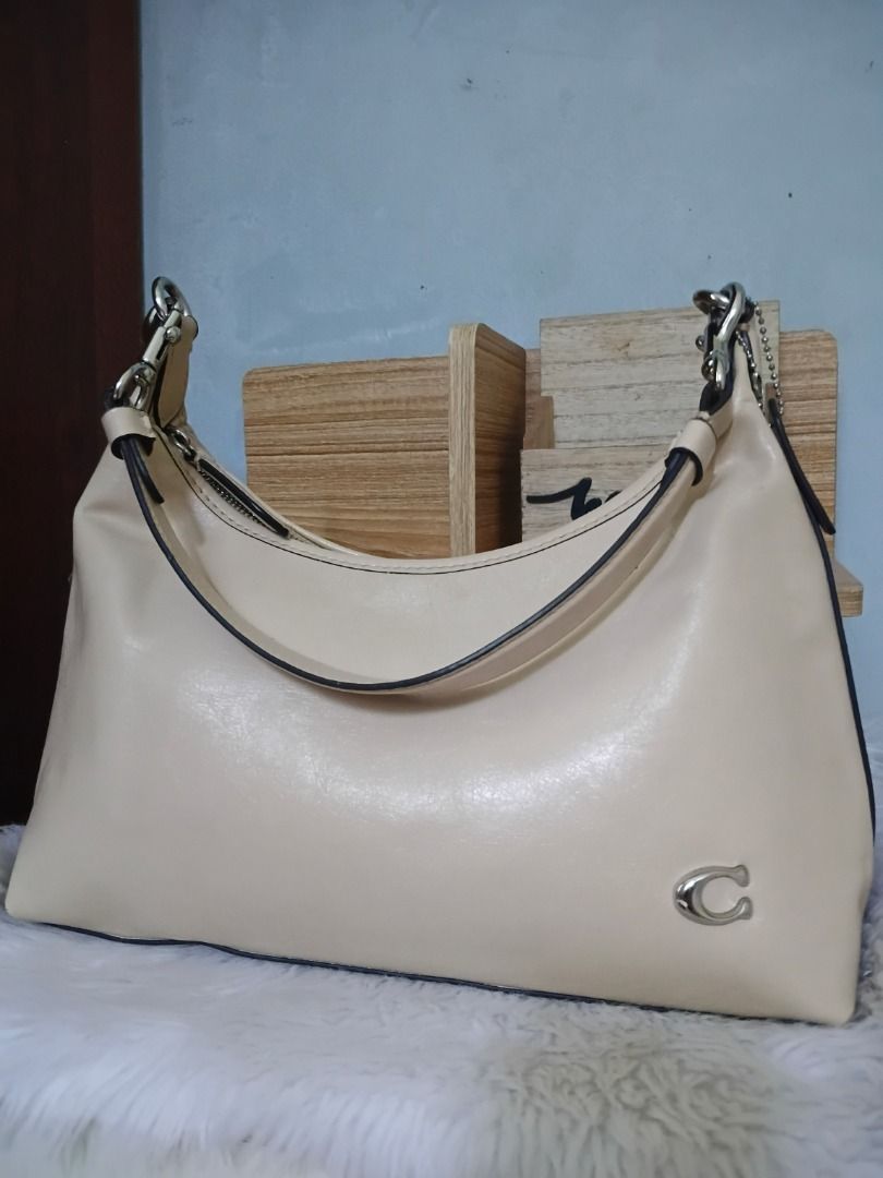Cream Hobo Shoulder Bag with Silver Hardware (Category: Shoulder Bags) located in Lucena. Submitted by gracious_chin0436 (Listing ID 1466786758, Image 1). Description: - Color: Cream - Style: Curved hobo shoulder bag with top zipper closure - Hardware: Silver-tone with matching detachable charm hangtag - Interior: Clean lining with a flat structured base - Capacity: Spacious enough for all your daily essentials with minimal flaw on corners back p
