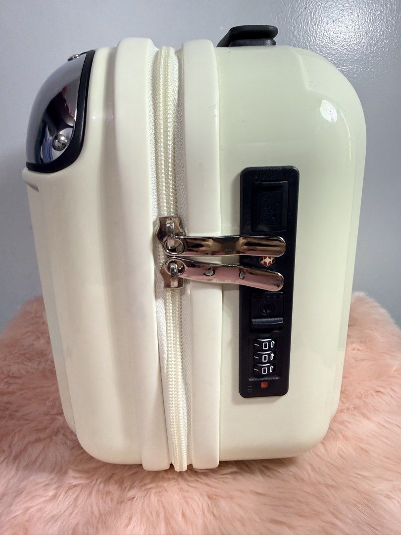 Cream mini hard shell travel suitcase with combo lock (Category: Luggage) located in Quezon City. Submitted by shaberbree (Listing ID 1466910099, Image 2). Description: - Color: Cream - Design: Chic vertical ribbed hardshell with sturdy metal corner guards - Security: Built-in combination lock for safety - Tech-friendly: Convenient USB-C charging port slot on the side - Travel-friendly: Features a back strap to easily slide over larger luggage ha