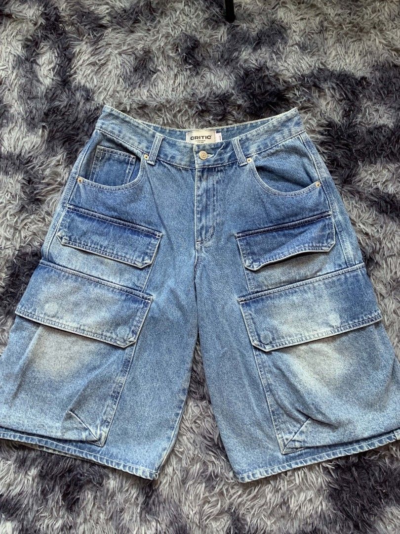 Critic Denim Cargo Shorts (Category: Shorts) located in Pagadian. Submitted by duskthrift (Listing ID 1466778351, Image 1). Description: - Brand: Critic (Korean streetwear brand) - Item: Denim cargo shorts - Size: Medium - Color/Wash: Medium wash with distressing - Material: 100% heavyweight cotton - Features: Multiple utility pockets on front, sides, and back - Condition: Brand new with waist and interior tags attached.