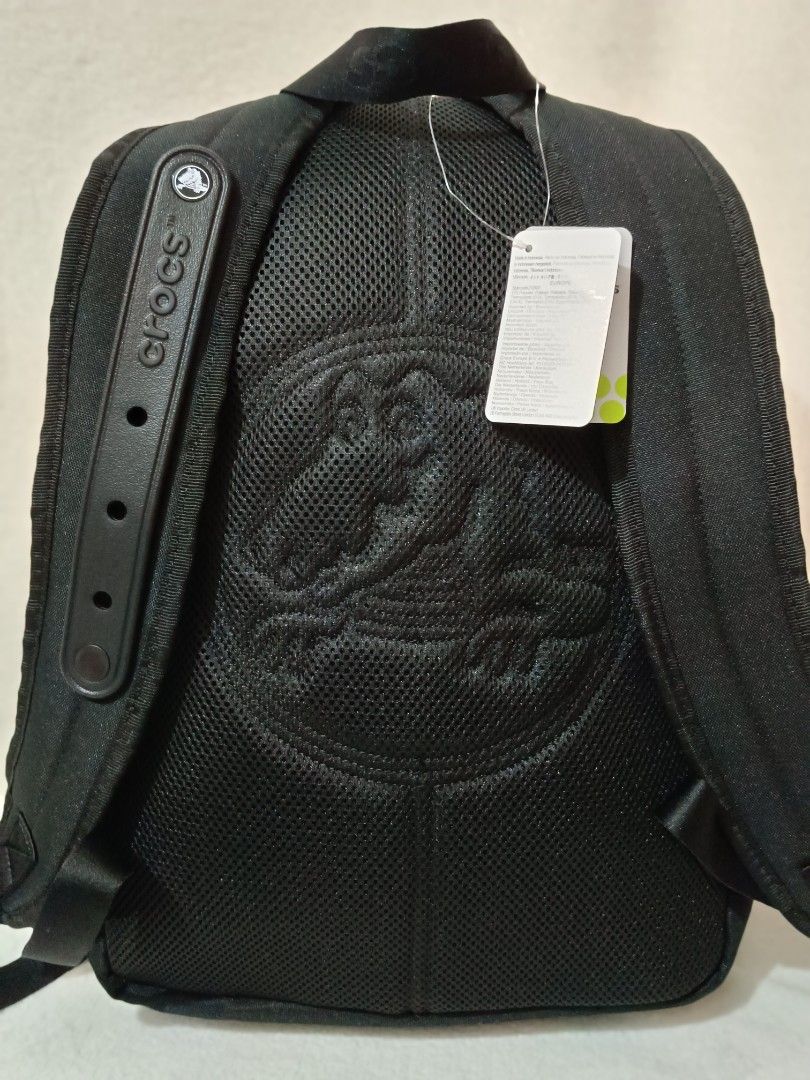 Crocs Black Backpack with Jibbitz Holes (Category: Backpacks) located in Quezon City. Submitted by shinereign (Listing ID 1466843854, Image 2). Description: - Brand new with original store tags attached - Color: Classic Black - Signature perforated front pocket design - Croslite-inspired texture details with embossed logo patch - Padded mesh back panel featuring the Crocs alligator mascot logo - Adjustable shoulder straps with branded strap keepe
